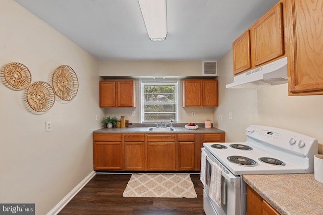 4419 Lakeview Dr, Temple Hills, MD 20748 - kitchen featuring electric stove, under cabinet range hood, dark wood finished floors, and brown cabinetry