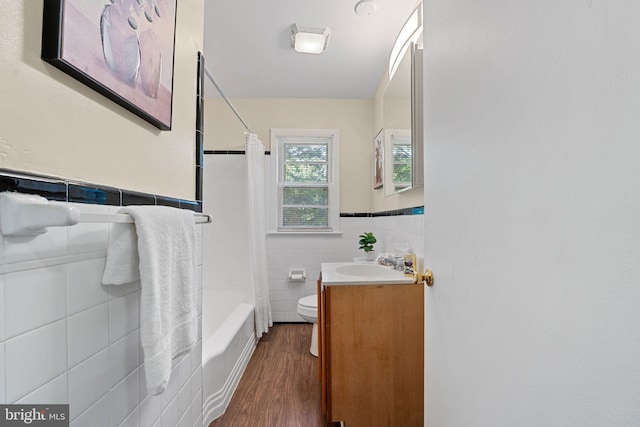 4419 Lakeview Dr, Temple Hills, MD 20748 - bathroom with tile walls, toilet, wood finished floors, vanity, and a wainscoted wall