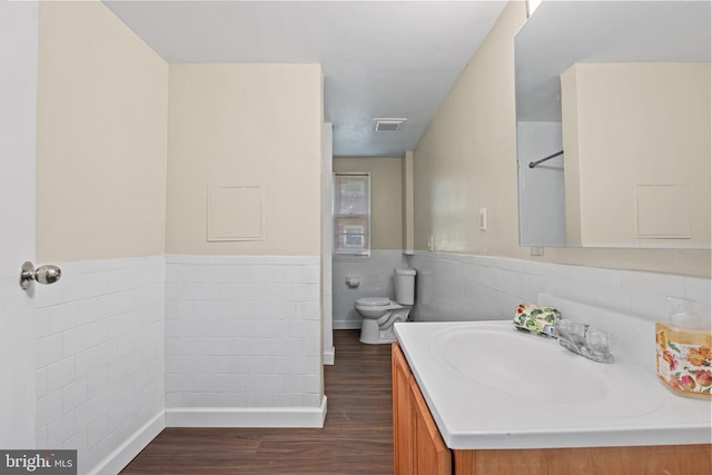 4419 Lakeview Dr, Temple Hills, MD 20748 - bathroom with tile walls, wood finished floors, toilet, vanity, and wainscoting