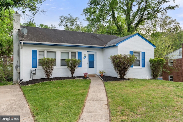 4419 Lakeview Dr, Temple Hills, MD 20748 - view of front facade with a chimney, brick siding, a front yard, and roof with shingles