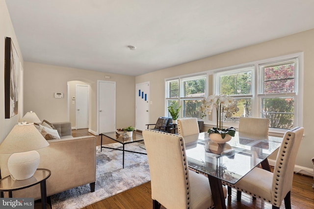 4419 Lakeview Dr, Temple Hills, MD 20748 - dining room featuring arched walkways, wood finished floors, and baseboards