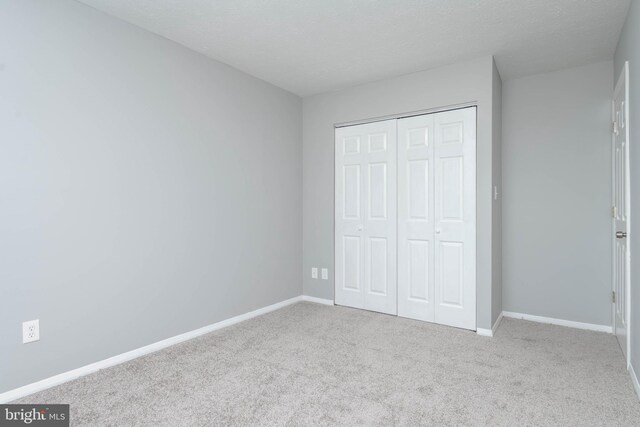 17 Powhurst Ct, Nottingham, MD 21236 - unfurnished bedroom featuring carpet, a closet, baseboards, and a textured ceiling