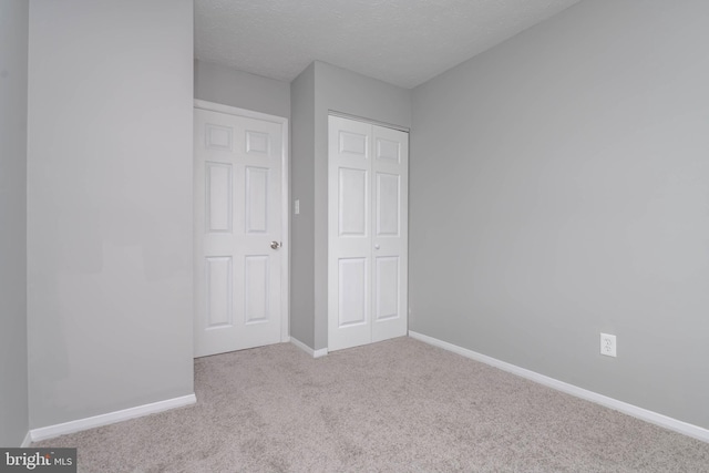 17 Powhurst Ct, Nottingham, MD 21236 - unfurnished bedroom with carpet flooring, a closet, baseboards, and a textured ceiling