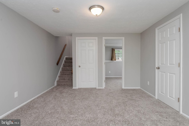 17 Powhurst Ct, Nottingham, MD 21236 - basement with carpet floors, baseboards, stairway, and a textured ceiling