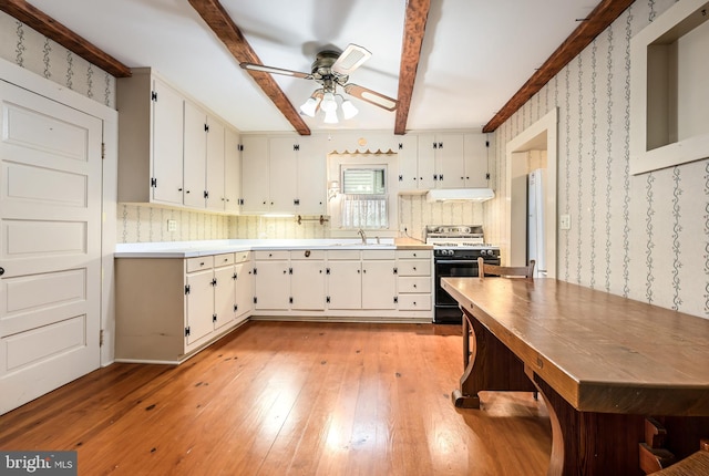 109 Chew Ave W, Saint Michaels, MD 21663 - kitchen with range with gas stovetop, extractor fan, ceiling fan, light wood finished floors, and wallpapered walls
