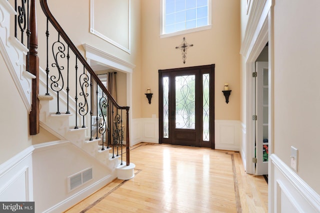 13 Lenape Ct, Mount Laurel, NJ 08054 - entryway with a decorative wall, plenty of natural light, a wainscoted wall, a towering ceiling, and wood finished floors