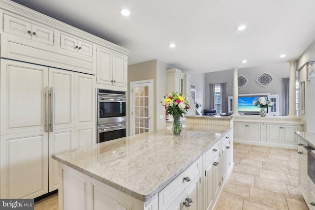 13 Lenape Ct, Mount Laurel, NJ 08054 - kitchen with stainless steel double oven, paneled refrigerator, a center island, recessed lighting, and light stone counters