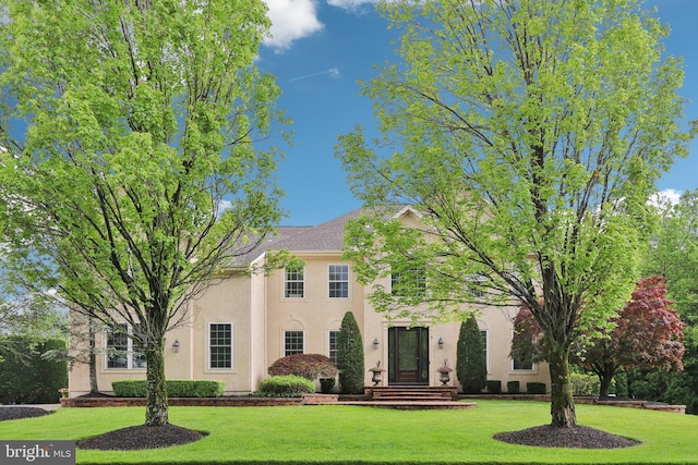 13 Lenape Ct, Mount Laurel, NJ 08054 - view of front facade with stucco siding and a front lawn