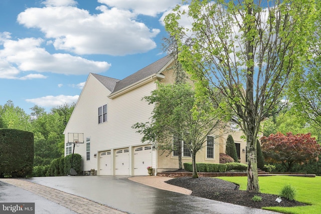 13 Lenape Ct, Mount Laurel, NJ 08054 - view of property exterior featuring an attached garage, driveway, and a yard