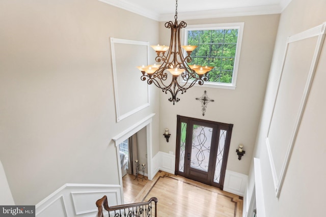 13 Lenape Ct, Mount Laurel, NJ 08054 - foyer featuring a chandelier, a decorative wall, light wood-type flooring, crown molding, and wainscoting