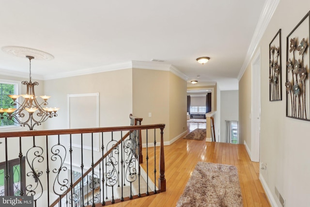 13 Lenape Ct, Mount Laurel, NJ 08054 - hallway with a chandelier, light wood finished floors, an upstairs landing, plenty of natural light, and crown molding