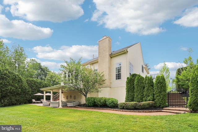 13 Lenape Ct, Mount Laurel, NJ 08054 - rear view of house with an outdoor hangout area, a chimney, a yard, a patio, and stucco siding