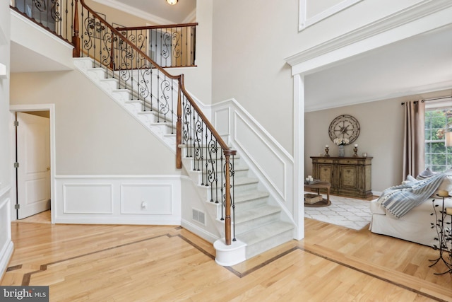 13 Lenape Ct, Mount Laurel, NJ 08054 - staircase with wood finished floors, a decorative wall, ornamental molding, and a wainscoted wall