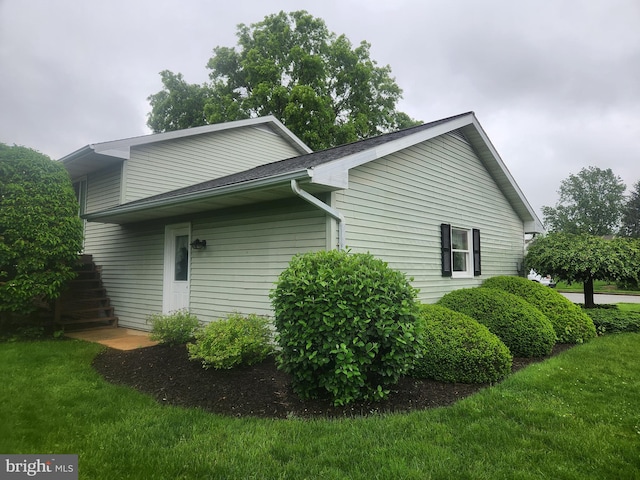 view of home's exterior with a yard