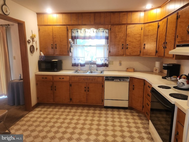 kitchen featuring dishwasher, black microwave, range with electric cooktop, a sink, and under cabinet range hood