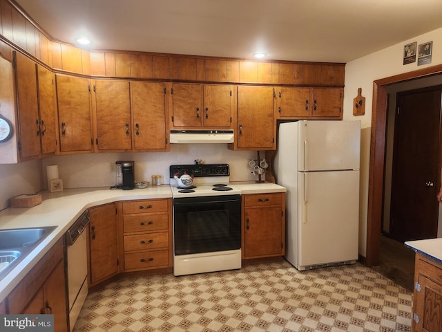 kitchen featuring freestanding refrigerator, electric stove, under cabinet range hood, brown cabinetry, and recessed lighting