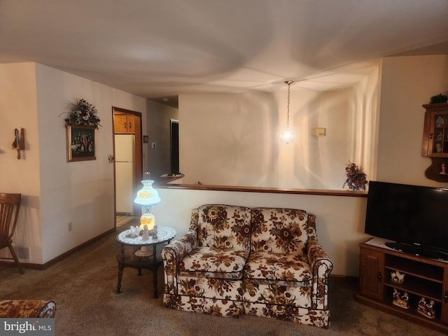 sitting room featuring carpet flooring and baseboards