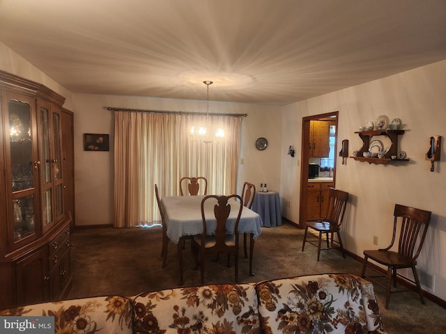dining area featuring dark carpet, a chandelier, and baseboards