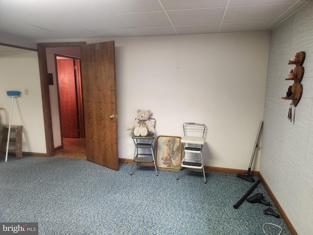 living area featuring baseboards and carpet flooring