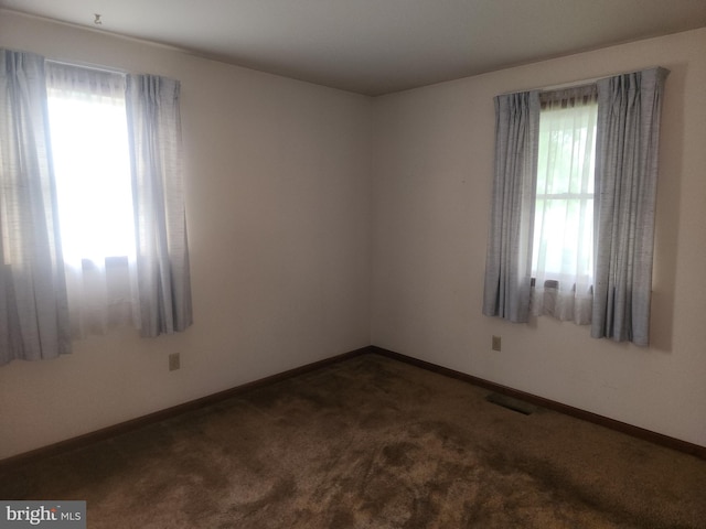 carpeted spare room with baseboards