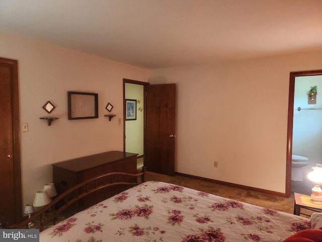 bedroom with carpet flooring, baseboards, and connected bathroom
