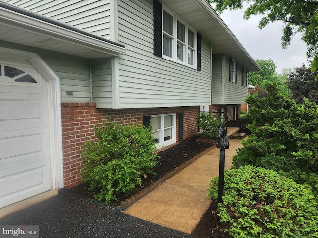 view of side of property with brick siding