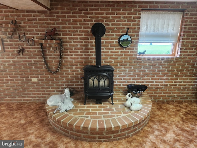 detailed view of carpet, brick wall, and a wood stove