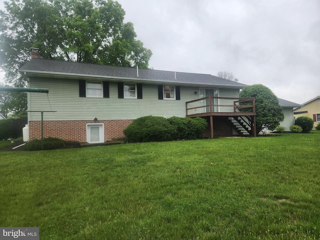 back of property featuring a wooden deck, a lawn, stairs, and a chimney