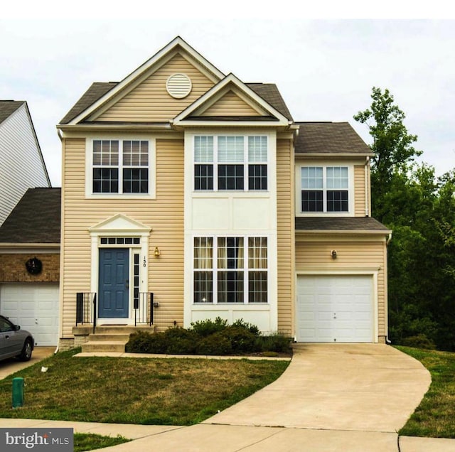 view of front of property featuring driveway, a front lawn, and an attached garage