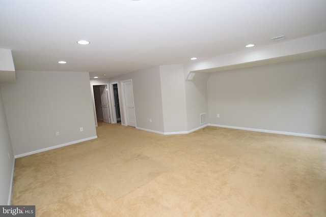 finished basement with recessed lighting, light colored carpet, and baseboards