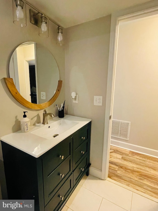 bathroom featuring vanity, baseboards, and tile patterned flooring