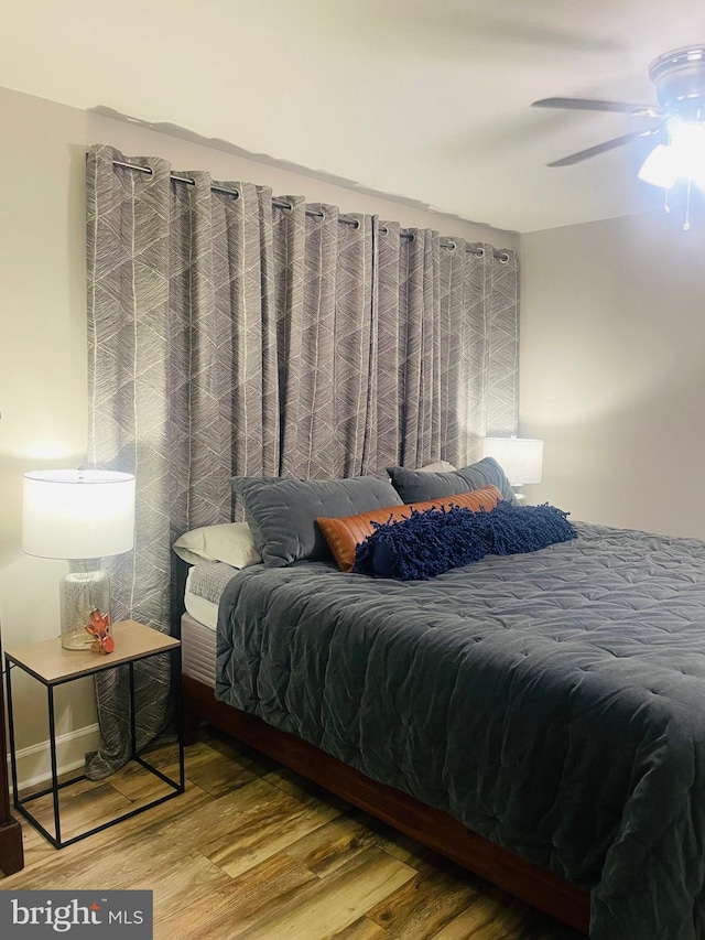 bedroom featuring wood finished floors and ceiling fan