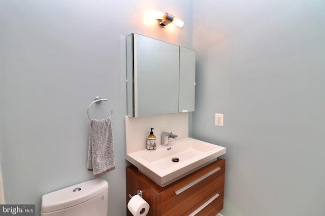 half bath with vanity and toilet