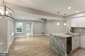 1611 Carriage House Ter, Silver Spring, MD 20904 - kitchen featuring black dishwasher, a sink, a peninsula, light wood-style flooring, and baseboards