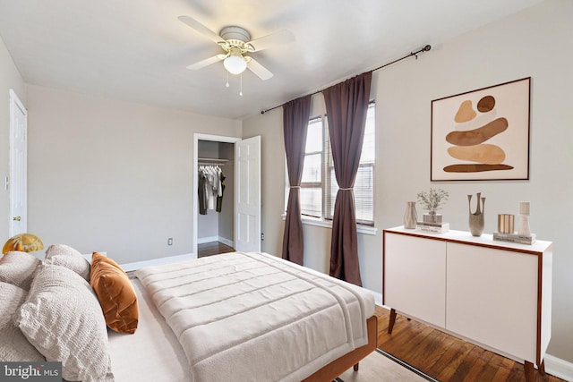 bedroom featuring wood finished floors, a ceiling fan, and a closet