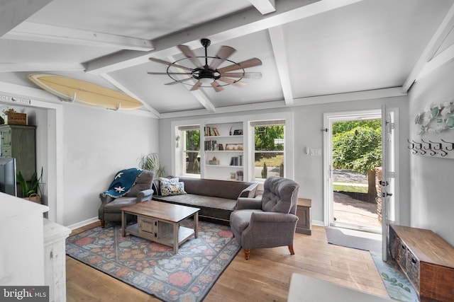 living room with light wood-style floors, a ceiling fan, and baseboards