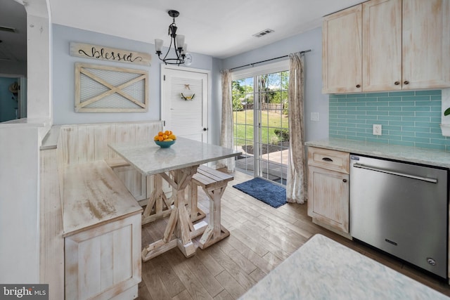 dining space featuring wood finished floors and a chandelier
