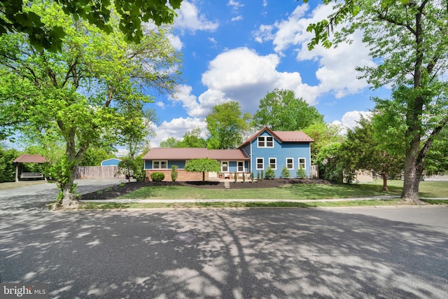 view of front of home featuring concrete driveway and metal roof