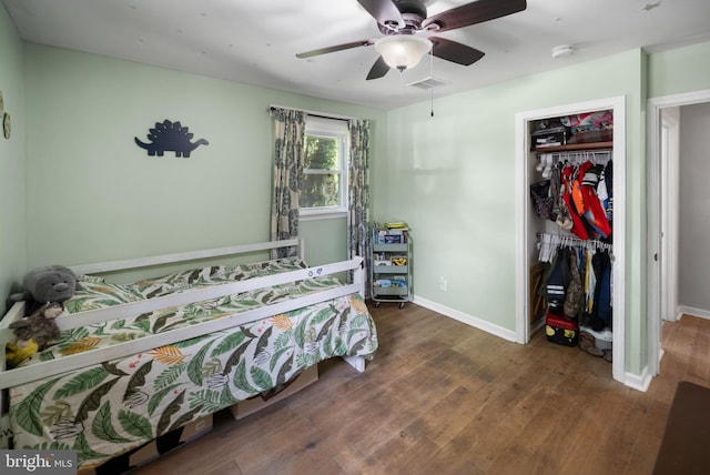 bedroom featuring wood finished floors, a closet, and baseboards