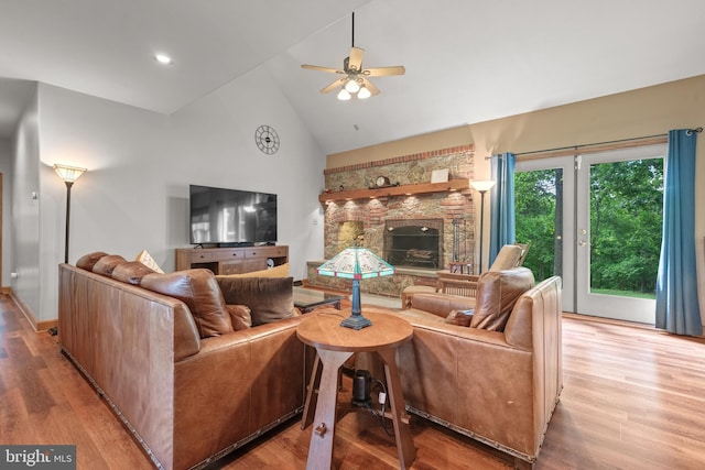 12451 High Point Rd, Felton, PA 17322 - living room with a stone fireplace, ceiling fan, high vaulted ceiling, and light wood-style floors