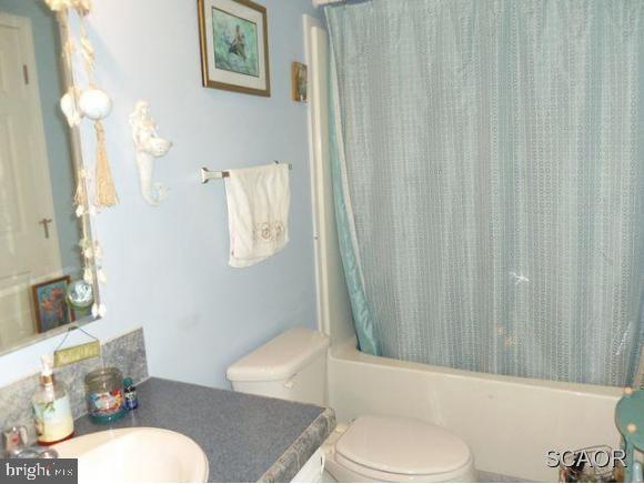 38802 Tyler Ave, Selbyville, DE 19975 - bathroom with vanity, toilet, and shower / bath combination with curtain