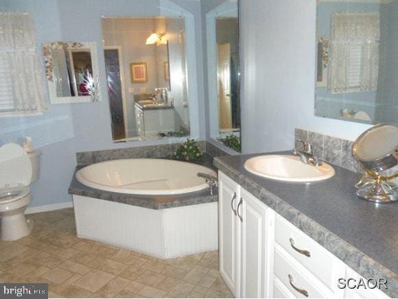 38802 Tyler Ave, Selbyville, DE 19975 - bathroom with a bath, toilet, vanity, and stone finish floors