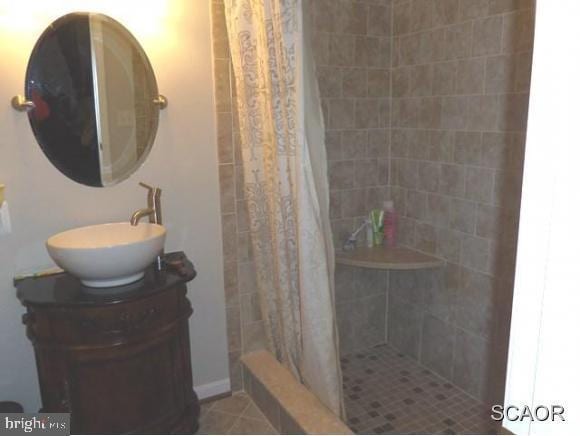 38802 Tyler Ave, Selbyville, DE 19975 - bathroom with vanity, tiled shower, and tile patterned floors