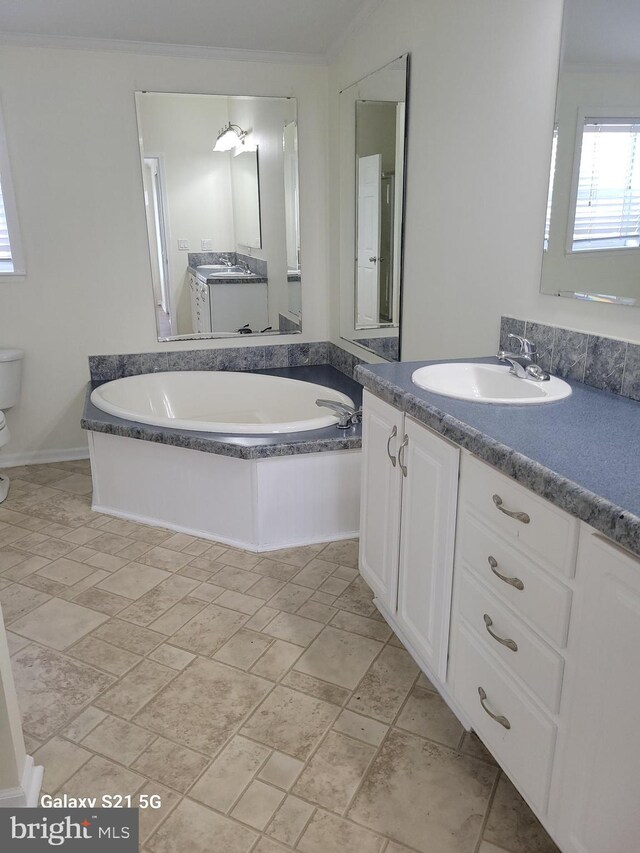 38802 Tyler Ave, Selbyville, DE 19975 - full bathroom with vanity, a garden tub, ornamental molding, and toilet