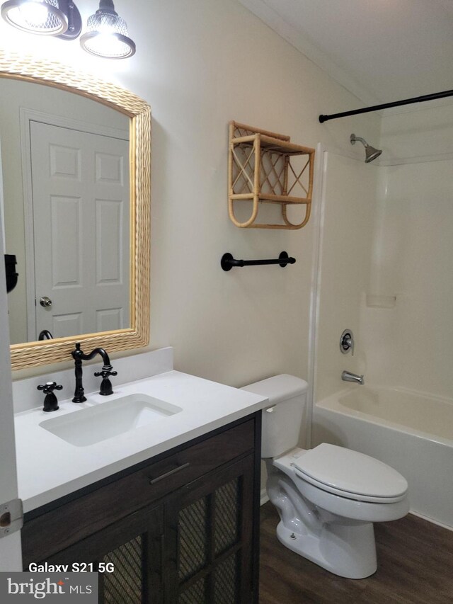 38802 Tyler Ave, Selbyville, DE 19975 - full bath featuring toilet, vanity, wood finished floors, and tub / shower combination