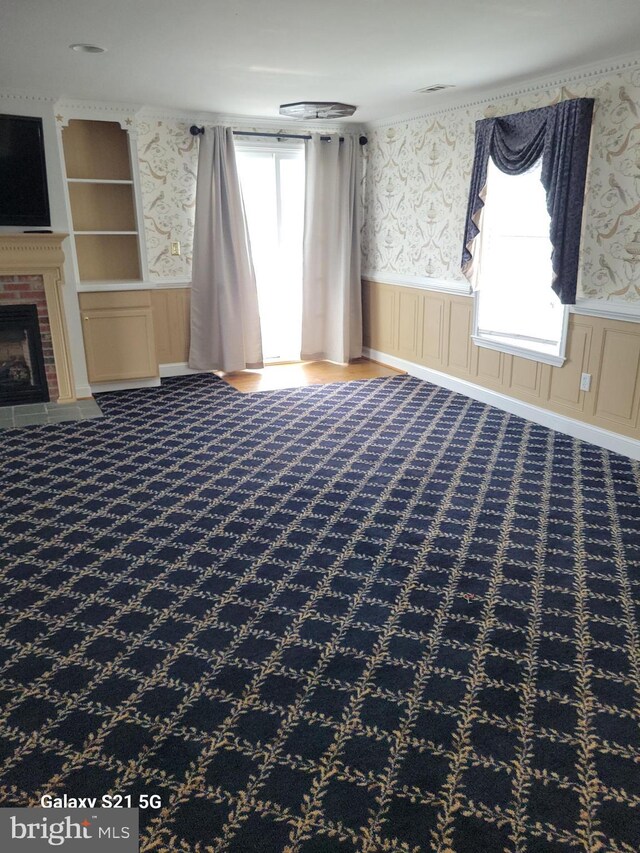 38802 Tyler Ave, Selbyville, DE 19975 - unfurnished living room featuring wallpapered walls, wainscoting, and a fireplace