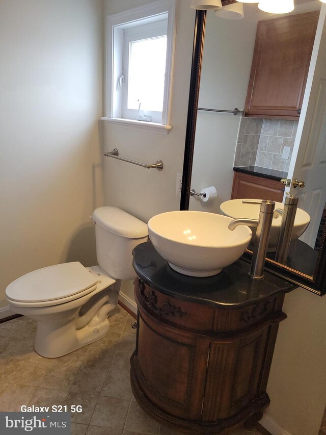 38802 Tyler Ave, Selbyville, DE 19975 - bathroom with decorative backsplash, vanity, toilet, baseboards, and a fireplace