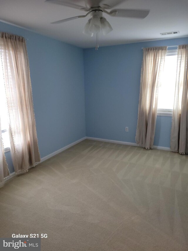38802 Tyler Ave, Selbyville, DE 19975 - spare room with light carpet, a ceiling fan, and baseboards