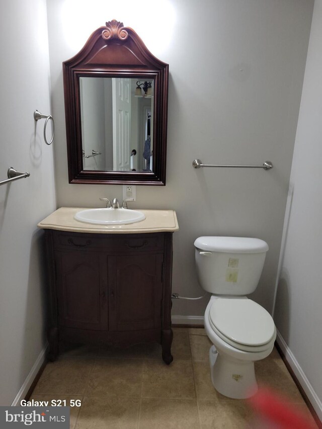 38802 Tyler Ave, Selbyville, DE 19975 - half bathroom with baseboards, vanity, toilet, and tile patterned flooring