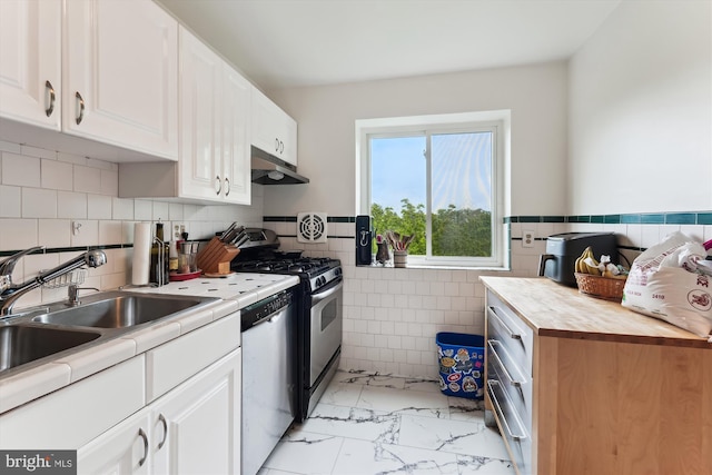 614 Sligo Ave Unit 504, Silver Spring, MD 20910 - kitchen featuring stainless steel appliances, under cabinet range hood, tile walls, light marble finish flooring, and white cabinetry